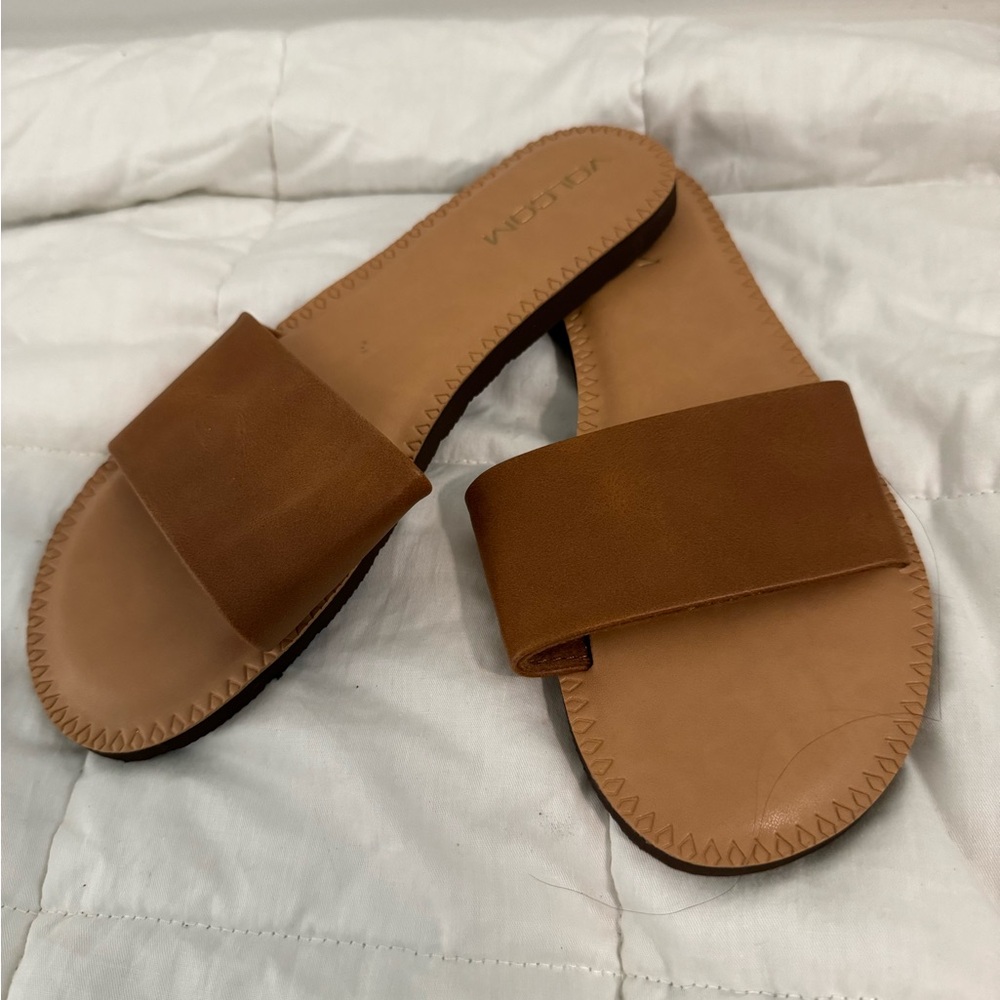 Brown volcom flip flops